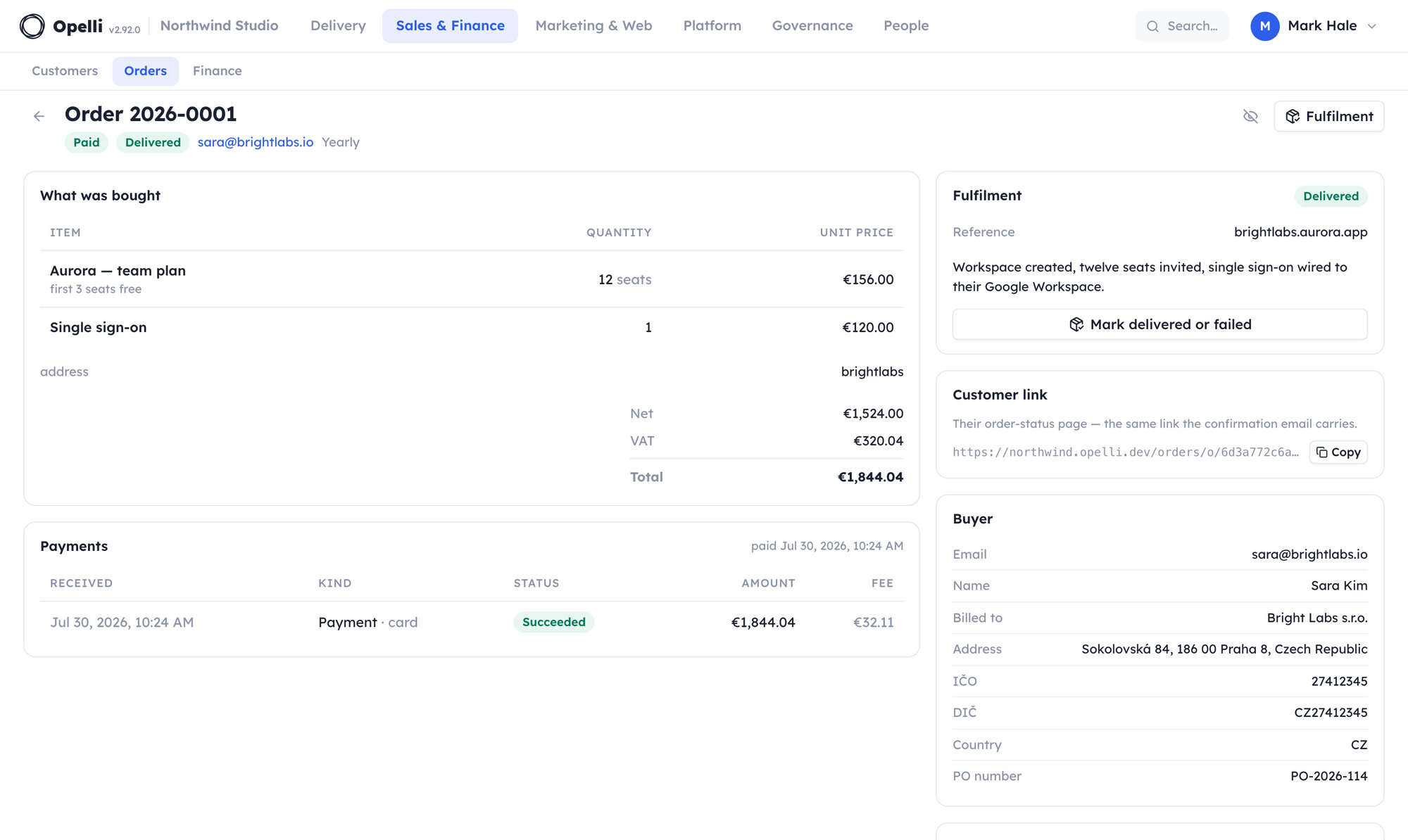 One paid order opened as a page: the lines and frozen totals, the address the buyer chose, the card payment with its fee, and the fulfilment recorded beside the billing details.